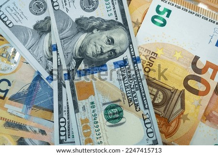 Pile of USD and Euro cash money banknotes