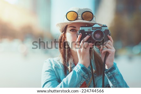 Hipster girl with retro camera. Focus on camera