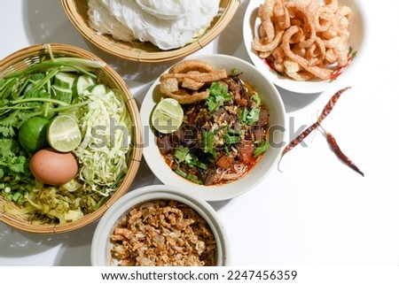 Khanom Jin Nam Ngiao. Rice noodles with spicy pork sauce.with northern Thailand traditional Lanna food. rice vermicelli with northern thai curry sauce Royalty-Free Stock Photo #2247456359