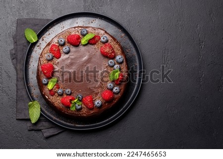 Chocolate cake dessert with fresh berries. Flat lay with copy space