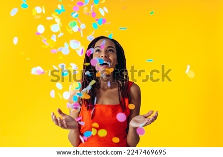 Image of a beautiful young woman posing on colored backgrounds wearing colorful trendy clothes. Concept about carefree, fashion and lifestyle