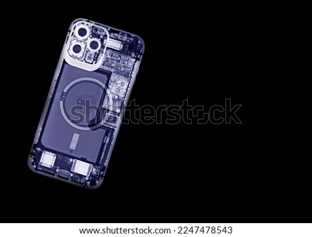 An x-ray of a mobile phone shows the internal parts of the device. Royalty-Free Stock Photo #2247478543