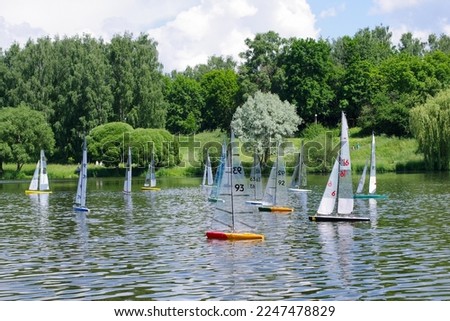 RC Yachts on city lake. Model ships race. Royalty-Free Stock Photo #2247478829