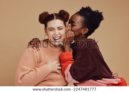 Friends, gossip and women laughing at secret joke on studio background with smile on face. Secrets, rumor and whisper in ear, black woman with happy woman discuss funny announcement for advertisement Royalty-Free Stock Photo #2247481777