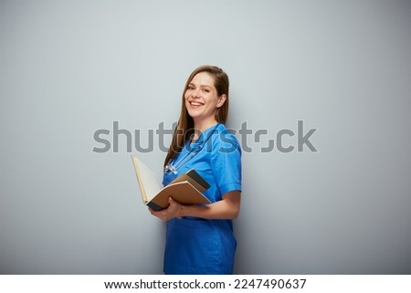 Smiling medical student with book. Isolated portrait of female medical worker.