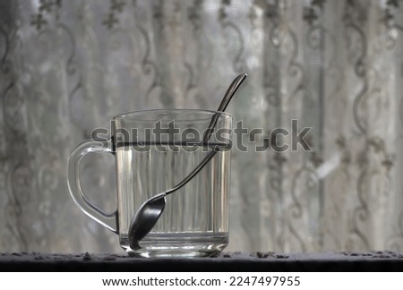 Refraction of the light. Tea spoon inside a glass of water, light refraction.       Royalty-Free Stock Photo #2247497955