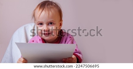 Humorous image of little happy business child girl with document, she holding contract.