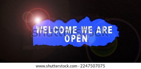 Sign displaying Welcome We Are Open. Word Written on Greeting making part of a work group new people