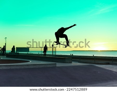 silhouette skateboarder jumping in a skatepark