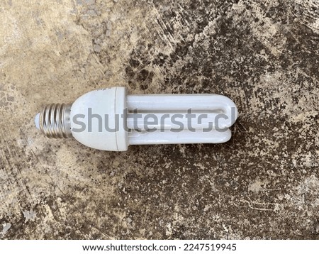 Small light bulb is standing and glowing while the big ones was laying down, advantage of small thing, small business in competition idea, find a niche business