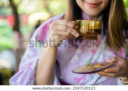 Closeup image of kimono woman drinking japanese tea 
