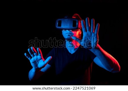 A young man using high-tech virtual reality glasses