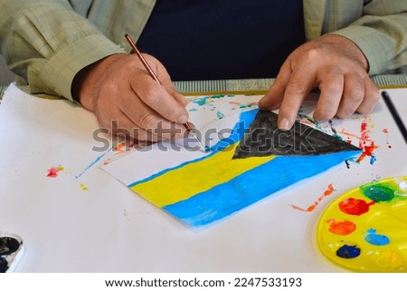 The flag of the Bahamas is drawn by the artist with watercolors on a sheet of parchment.