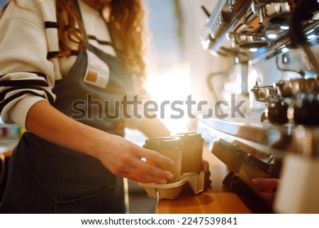 Сoffee to go. Barista girl holding take away coffee at the cafe shop. Takeaway food. Royalty-Free Stock Photo #2247539841