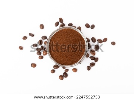 Ground coffee and coffee beans in a bowl isolated on white background.