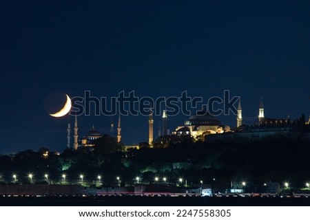 Islamic photo. Sultanahmet or Blue Mosque and Hagia Sophia with crescent moon. Ramadan or kandil or laylat al-qadr or islamic concept photo with copy space for text. Royalty-Free Stock Photo #2247558305