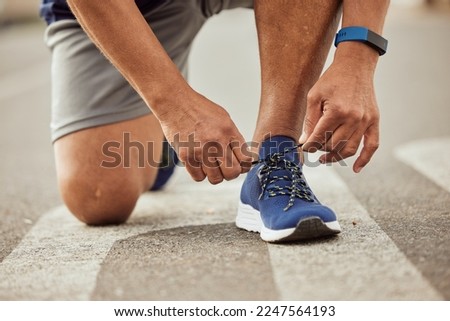 Sports, fitness or hands tie shoes to start training, cardio workout or exercise in city road. Legs, man or healthy athlete runner with running shoes or footwear laces ready for body goals or race Royalty-Free Stock Photo #2247564193
