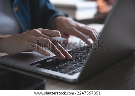 Young buisness woman online working, female hands typing on laptop computer and using digital tablet on office table at home, close up. Student studying online class, E-learning concept Royalty-Free Stock Photo #2247567351