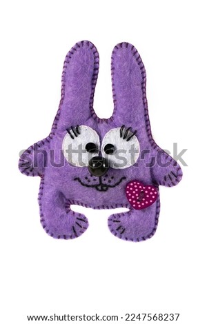 Homemade soft toy bunny for children on a white isolated background