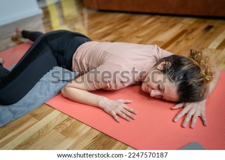 One adult caucasian woman practice restorative yoga at home Royalty-Free Stock Photo #2247570187