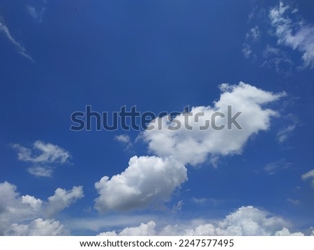 White clouds like cotton flutter in the blue sky