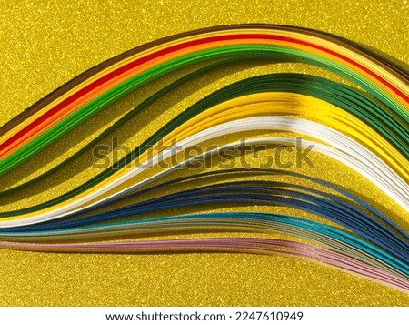 Abstract paper on sparkle golden background. Colorful strip wave paper on glitter gold. Sparkle paper texture. Minimalist paper concept. Template for card, print, poster. Golden glitter aesthetic.