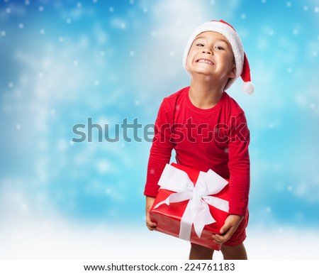 portrait of a little boy holding a heavy gift