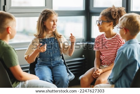 Group work of school children, multiracial students pupils discuss a collective project at school Royalty-Free Stock Photo #2247627303