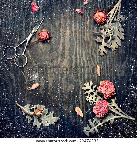 Vintage winter roses background on wooden textured table, toned photo