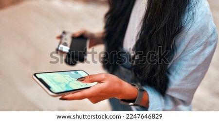 Asian female student tourist taking photos with retro camera on city streets and searching location in map online on smartphone, online navigator and travel concept. Vacation and tourism concept.