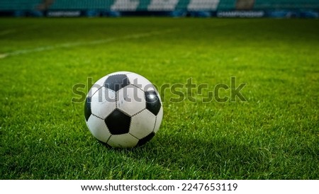 Close-up of a Football Ball. Conceptual Shot Representing Start of the Game, Success, Victory, Determination in Sport and Life. Low Angle Ground Artistic Shot. Establishing Shot