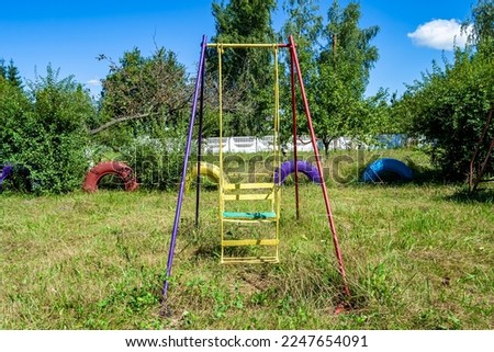 Photography on theme empty playground with metal swing for kids on background natural nature, photo consisting from playground with steel swing, swing on old playground in countryside without people