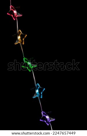 Colorful star shaped led lights garland isolated on black background