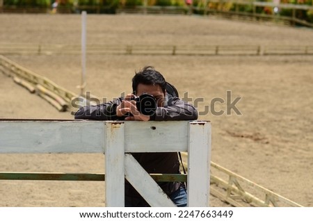 a man takes a picture using a camera