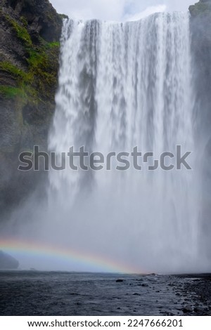 Long exposure view of famous Skógafoss waterfall with colourful sky and double rainbow. Magnificent Iceland in august. Fimmvörðuháls Hiking Trail. Popular Travel destinations