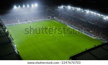 Aerial Establishing Shot of a Whole Stadium with Soccer Championship Match. Teams Play, Crowd of Fans Cheer. Football Tournament, Cup Broadcast. Sports Channel Television, Screen Content. Royalty-Free Stock Photo #2247676703