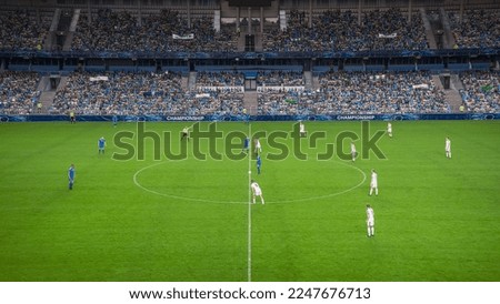 Soccer Football Championship Stadium with Crowd of Fans: Blue Team Starts The Game With Kick Off, Beginning of International Tournament Finals. Sport Channel Broadcast Television Concept. High Angle. Royalty-Free Stock Photo #2247676713
