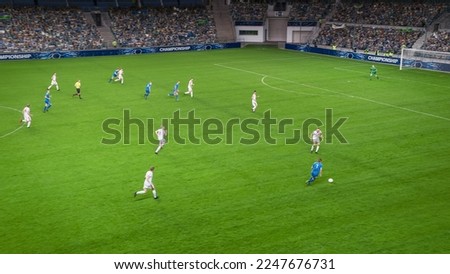 Soccer Football Championship Stadium with Crowd of Fans: Blue Team Forward Attacks, Dribbles, White Team Defending The Goals, Ready To Counterattack. Sports Channel TV Broadcast. High Angle. Royalty-Free Stock Photo #2247676731