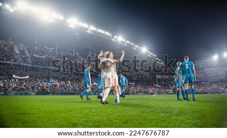 Football Championship: White Team Forward Hits the Ball and Scores Perfect Goal. Goalkeeper Jumps and Fails to Catch, Protect Goals. Teammates Celebrating Victory With a Hug. Beautiful Cinematic Edit. Royalty-Free Stock Photo #2247676787