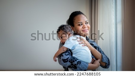 African family, 2-month-old baby newborn son is half-African halt-Thai on mother's shoulder, they are happy together. to baby newborn and family concept. Royalty-Free Stock Photo #2247688105