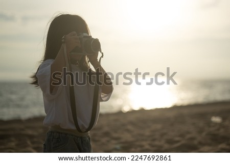 Child photographer, Little girl holding camera. Child taking photo.