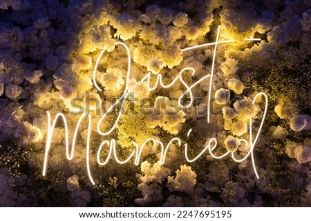 Led light inscription just married neon. wedding white floristic background peonies and hydrangea. Night light