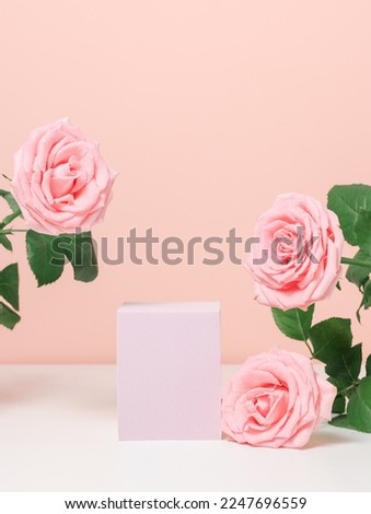 Beautiful podium with pink roses on pink background for product, gift and cosmetic presentation. Romantic showcase with copy space