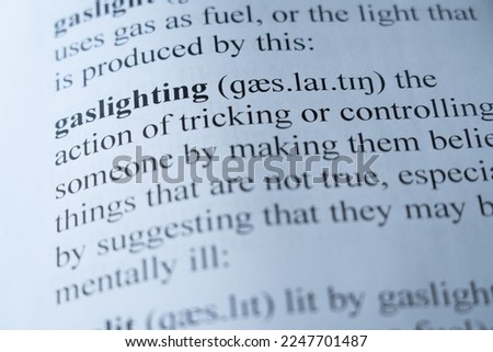 A mock up of a dictionary page with the word gaslighting with selective focussing Royalty-Free Stock Photo #2247701487