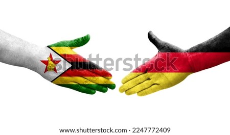 Handshake between Germany and Zimbabwe flags painted on hands, isolated transparent image.