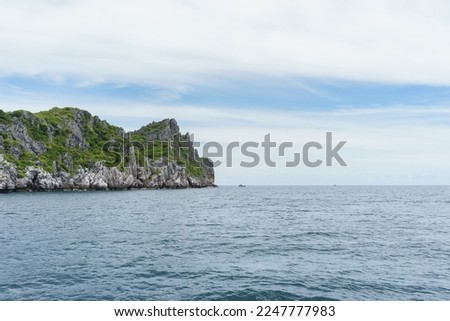 A photo of one of the many small islands around Ko Wao in Thailand. The picture was taken from a small boat on a sailing from Ko Phangan. 
