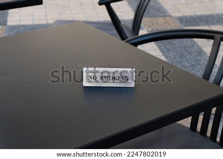 No smoking sign on table at restaurant.