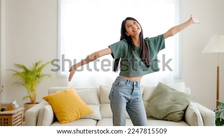Young asian woman dancing on the floor in living room at home. Happy asia female smile relaxing in house, healthy mental wellness and wellbeing Royalty-Free Stock Photo #2247815509