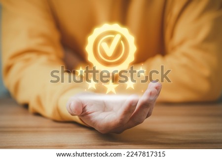 Adult man shows the sign of the top service the best quality assurance with golden five stars. Quality assurance of business services, Guarantee, Standards, ISO certification and testimonial concept. Royalty-Free Stock Photo #2247817315