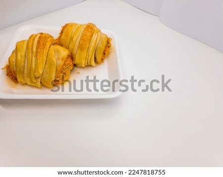 Delicious salted potato bread with creamy chicken filling isolated on a white background with copy space
